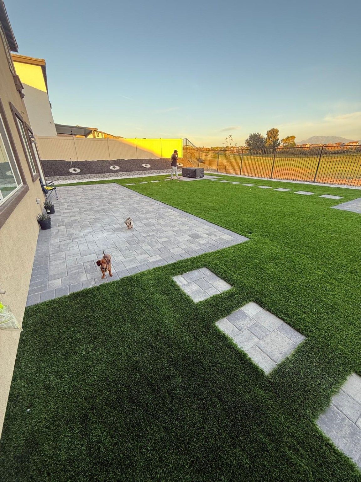 Backyard with pavers and artificial turf